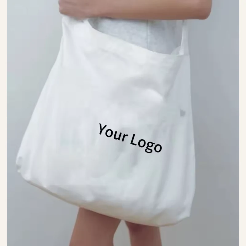 Soft white lightweight cotton tote carried by its handles