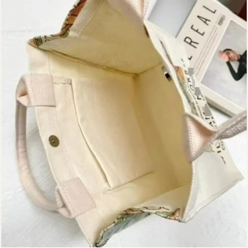 Open natural cotton tote showing its unlined interior and handles